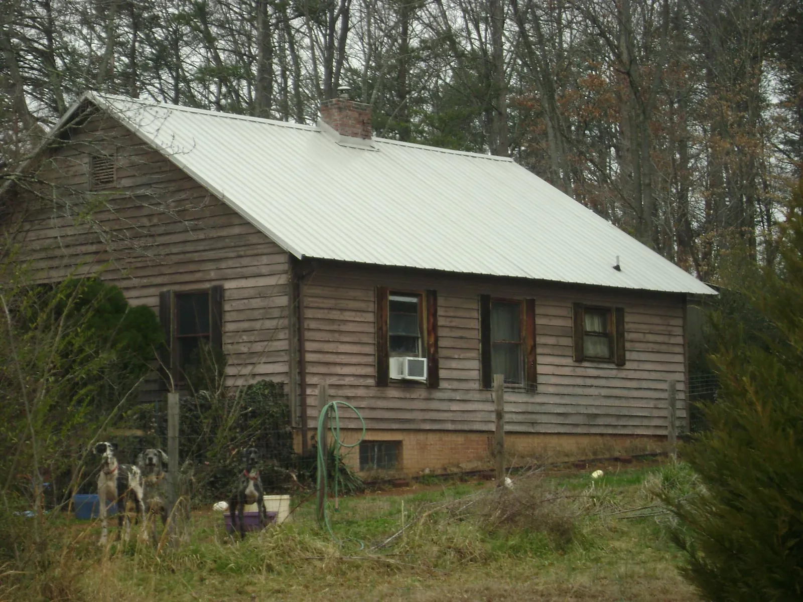White metal roof on an old wood sided farmhouse, from a Metal Roof Installation job in Inverness
